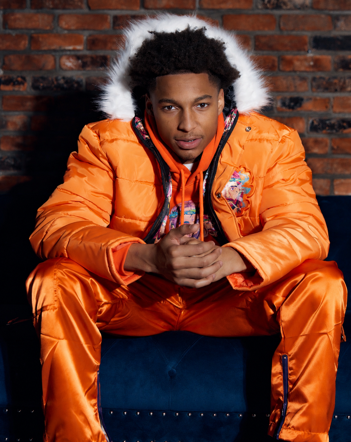 TMAC, also known as BBGTMAC, wearing an orange Jesus Smokes outfit